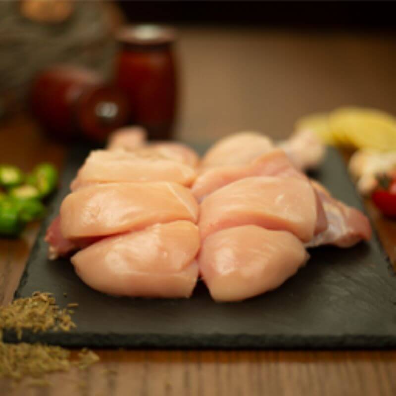 Premium, tender chicken biryani cuts on a stone platter, perfect for biryani and traditional dishes.