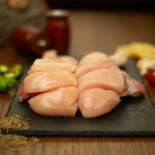 Premium, tender chicken biryani cuts on a stone platter, perfect for biryani and traditional dishes.